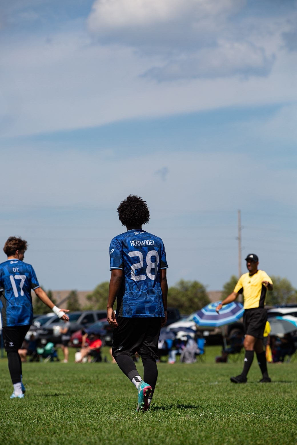 Number 28 walking upfield under a big sky