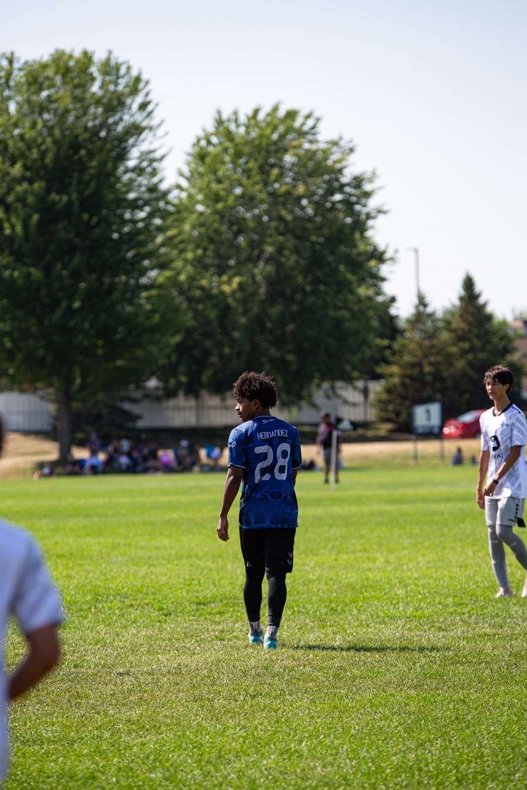 Midfielder glancing back mid-jog