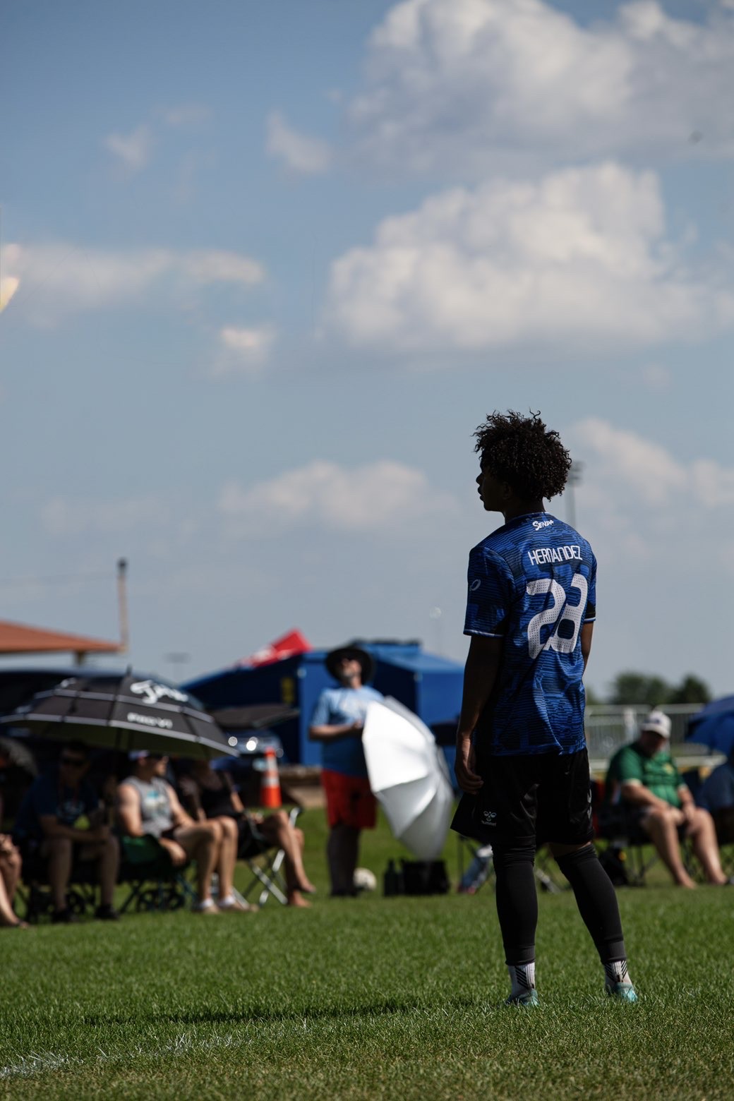 Soccer midfielder watching play develop from the sideline